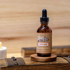 Bluegrass Bitters 5-Spice Orange Bitters on a wooden surface with a wooden background