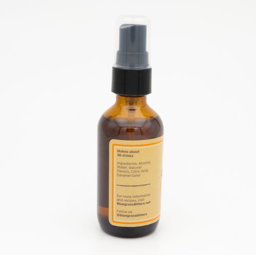 Amber glass bottle with a black spray nozzle on a white background