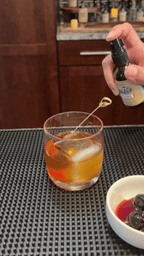 Bluegrass Bitters in a mister bottle spritzing the finishing touch on a cocktail